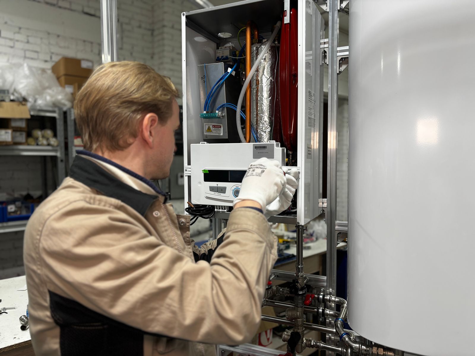 A heating engineer servicing a boiler and heating system